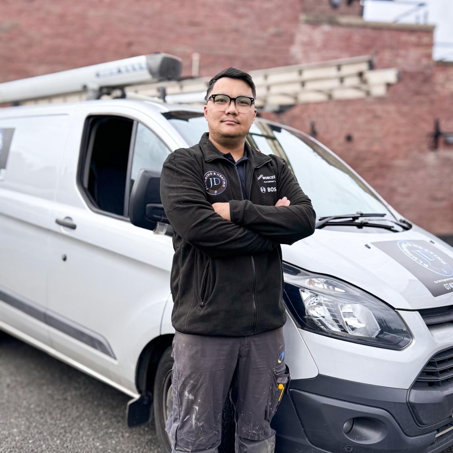 Man standing beside a van.