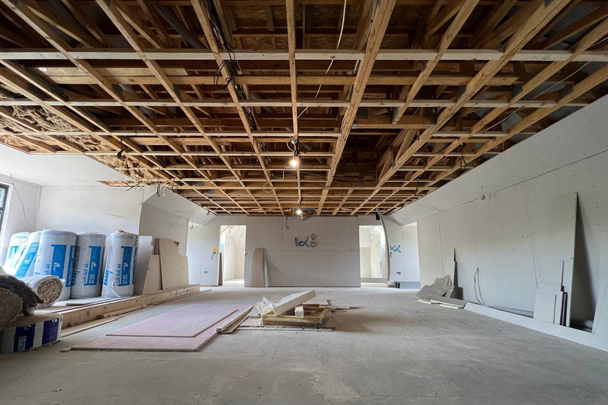 Empty room with exposed ceiling structure.