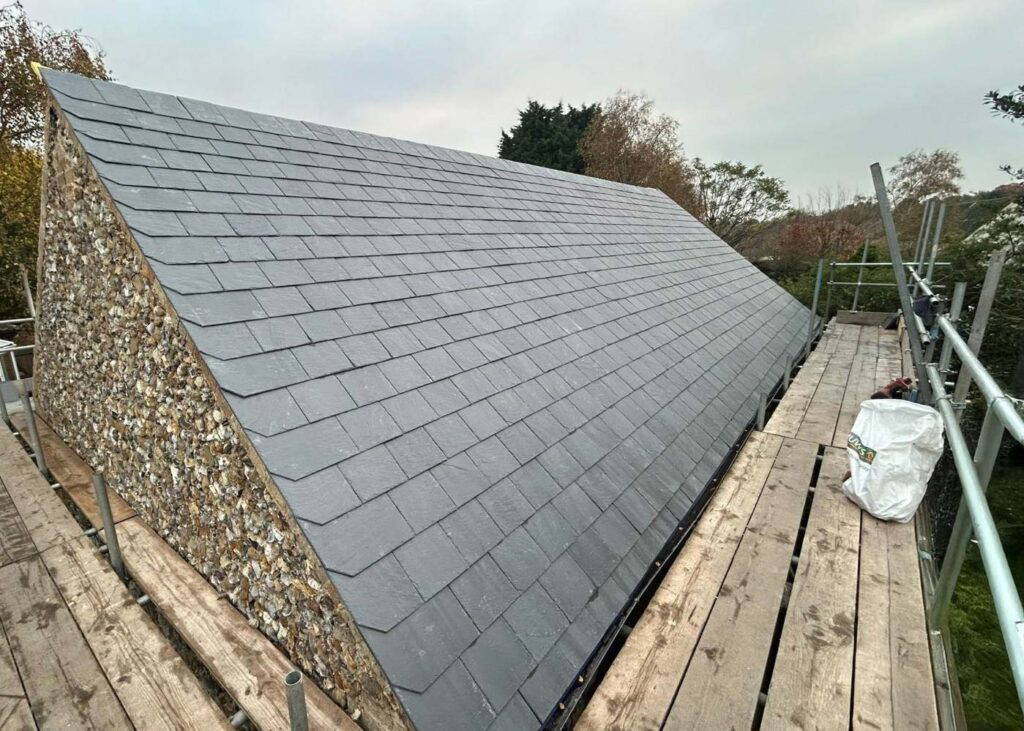 Newly installed slate roof on scaffolding.