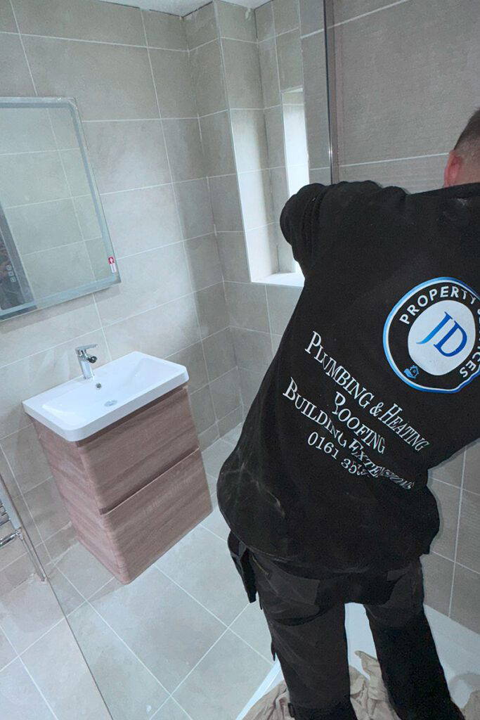 Worker installing bathroom fixtures