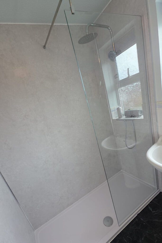 Modern shower with glass enclosure.