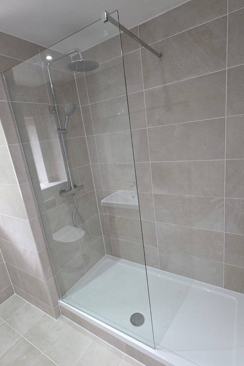 Modern shower with glass enclosure.