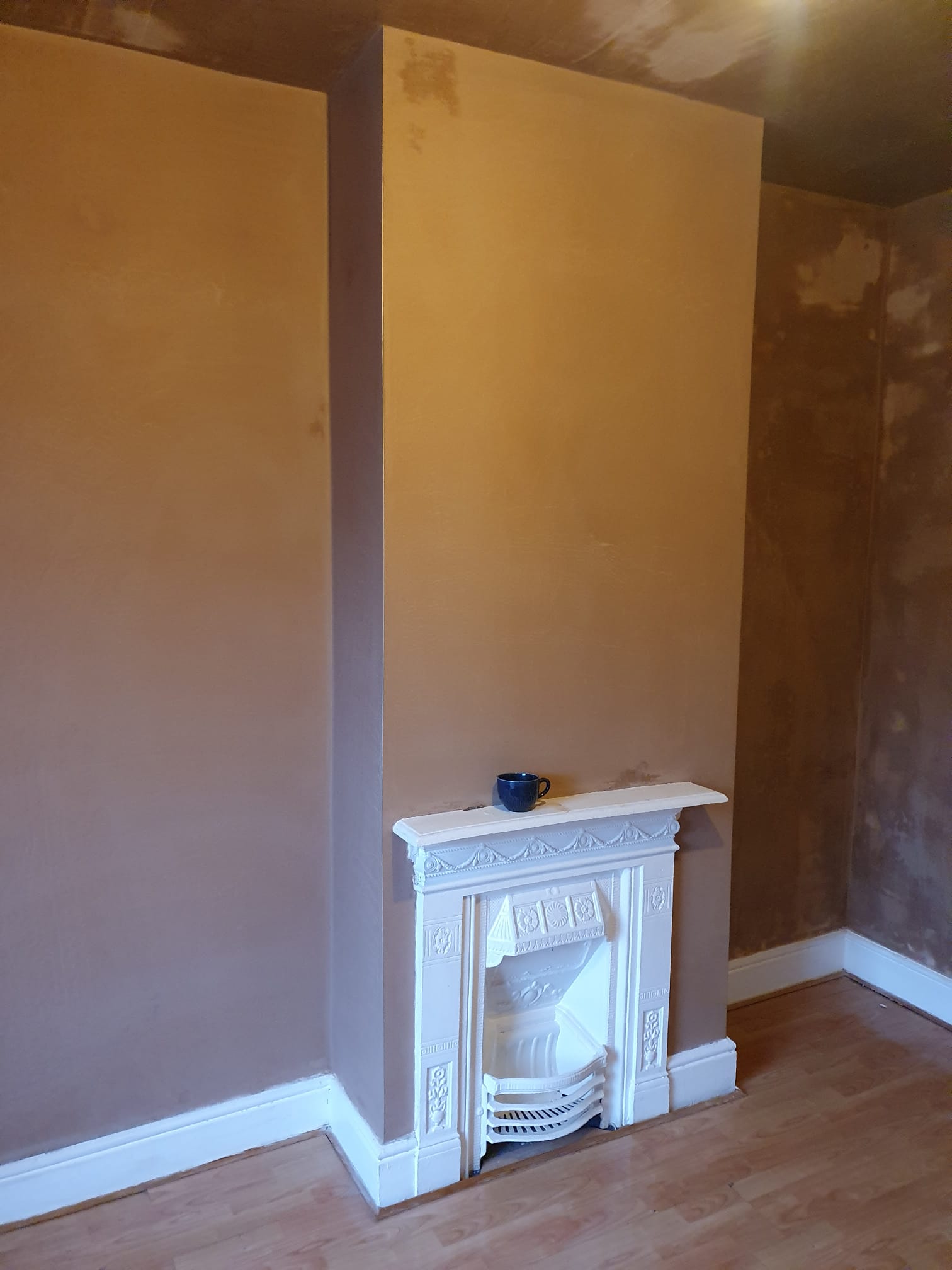 Freshly plastered walls with fireplace